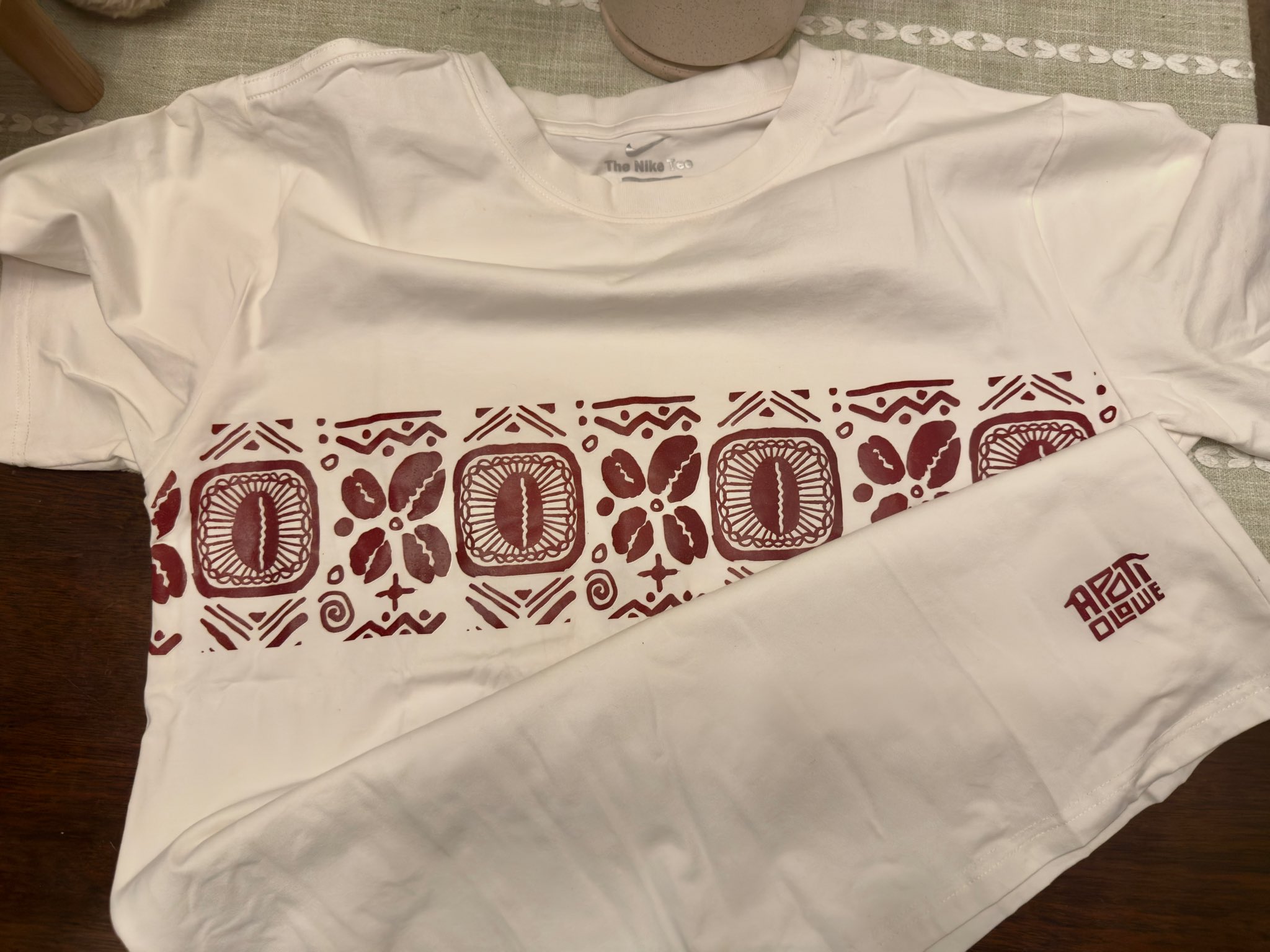 Client photo of a Kay's Works shirt with a red Apoti Olowe motif